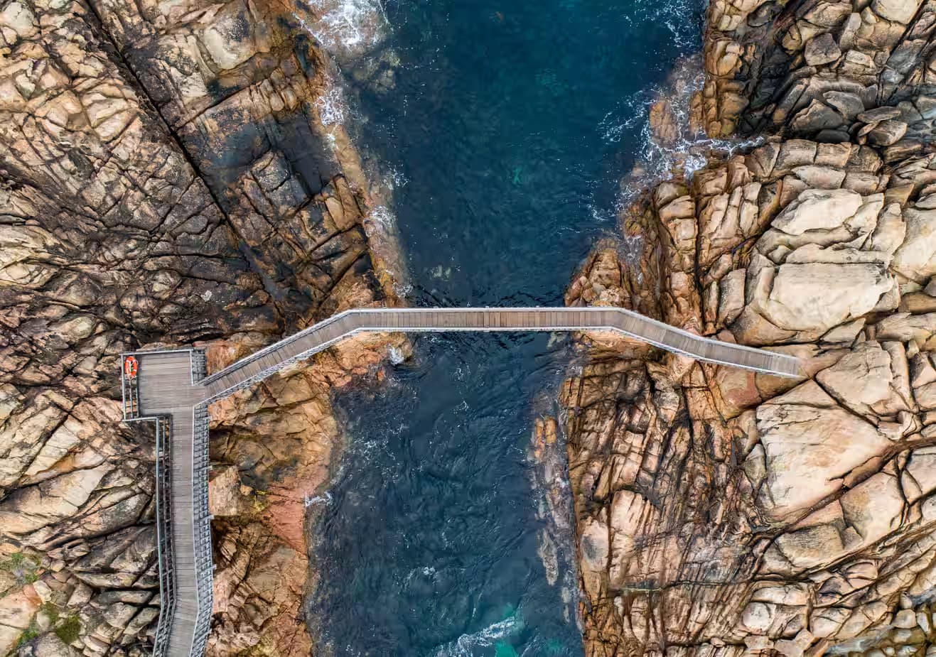 Bird's eye shot of a bridge crossing the sea